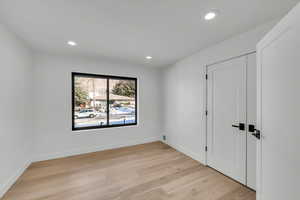 Unfurnished bedroom with light wood-type flooring and recessed lighting
