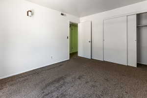 Unfurnished bedroom with carpet floors and a closet