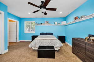 Primary Bedroom with carpet flooring, ceiling fan, recessed lighting, and a textured ceiling with abundant natural light
