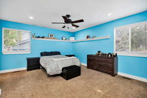 Primary Bedroom with carpet flooring, lots of natural light, a ceiling fan, recessed lighting, and a textured ceiling