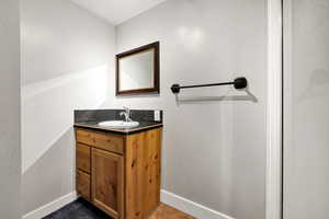 Bathroom with vanity and baseboards