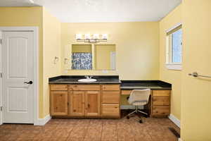 Full bathroom with a textured ceiling, vanity, tile floors, and a shower with curtain