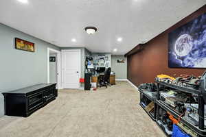Carpeted family room with recessed lighting and a textured ceiling
