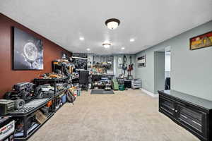 Family room, textured ceiling, carpet floors, and recessed lighting