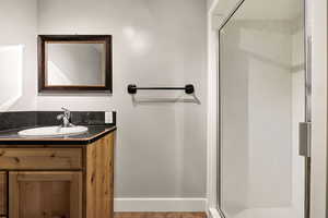 Full bath featuring vanity and a stall shower