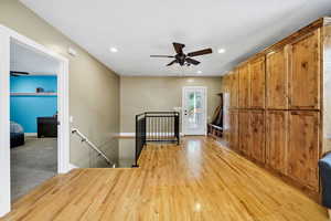 Unfurnished dining room with hardwood floors, a ceiling fan, recessed lighting, and a textured ceiling