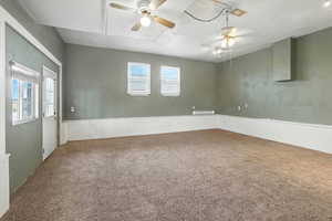Carpeted empty room with a ceiling fan