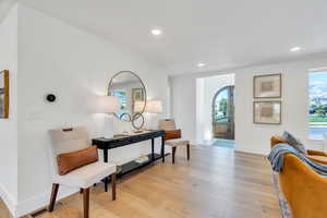 Sitting room with light wood-style flooring and recessed lighting