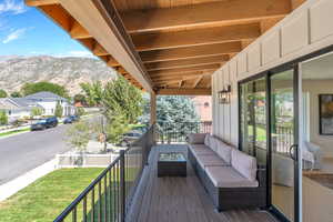 Deck with outdoor lounge area, a residential view, and a mountain view