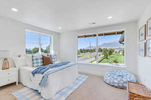 Bedroom with light colored carpet, a mountain view, and recessed lighting