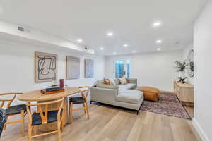 Living area featuring light wood-style flooring and recessed lighting