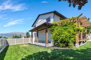 Back of property featuring a mountain view, a fenced backyard, and board and batten siding