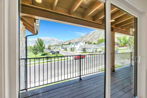 Deck with a residential view and a mountain view