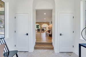 Entrance foyer with arched walkways and recessed lighting