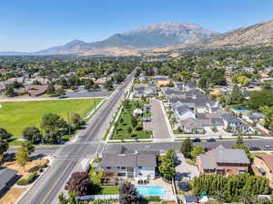 Aerial perspective of suburban area with a mountainous background and a pool