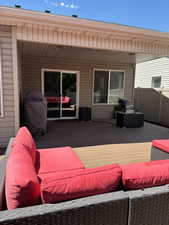 Deck with an outdoor hangout area and a grill