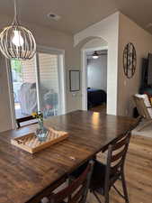 Dining room featuring arched walkways, a chandelier.