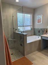 Full bath with a textured ceiling, a bath, a shower stall, vanity, and recessed lighting
