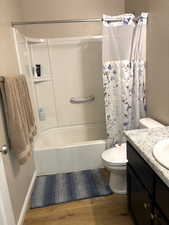 Bathroom with shower / bath combo and vanity.