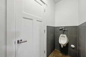 Bathroom featuring tile walls