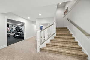 Stairs with carpet and recessed lighting
