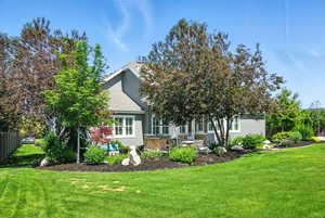 Back of property with stucco siding and a shingled roof