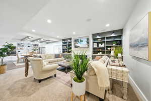 Living room with recessed lighting and built in shelves