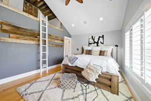 Bedroom featuring vaulted ceiling, wood finished floors, and recessed lighting
