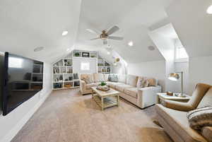 Living room featuring built in features, light carpet, lofted ceiling, a textured ceiling, and ceiling fan