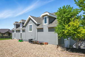 Back of house with stucco siding and roof with shingles