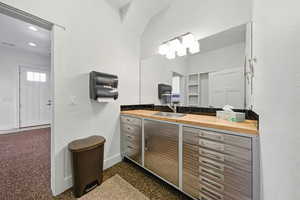 Bathroom featuring vanity and speckled floor