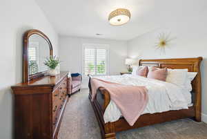 Bedroom featuring carpet floors and baseboards