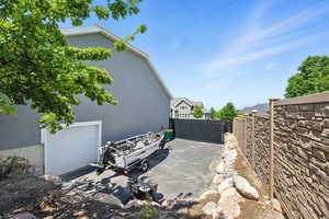 View of side of property featuring stucco siding and a garage