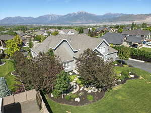 Aerial overview of property's location featuring nearby suburban area and a mountain backdrop