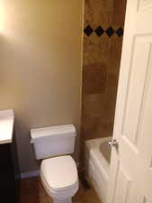 Bathroom featuring toilet and baseboards