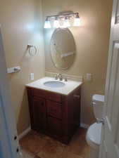 Half bath with vanity and tile patterned floors