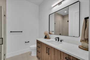 Full bathroom featuring vanity, a shower stall, tile patterned floors, and recessed lighting