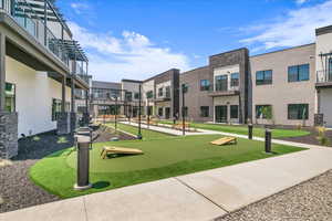 View of community with an area to practice putting and a residential view
