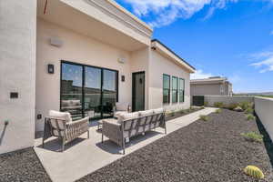 Fenced backyard with a patio area and an outdoor hangout area