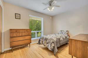 Bedroom with light wood-type flooring and a ceiling fan