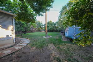 Fenced backyard with a storage shed