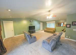 Carpeted second living area featuring a ceiling fan, recessed lighting, and vaulted ceiling