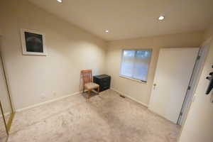 Living area with carpet floors and recessed lighting