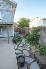 Fenced backyard with a patio