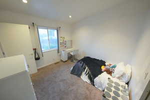 Bedroom with carpet, recessed lighting, and a desk