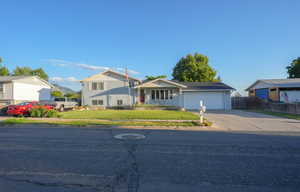 View of front of home featuring concrete driveway and an attached garage