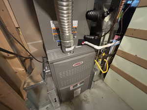 Utility room featuring heating unit