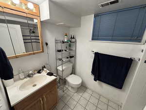Full bath featuring vanity, tile patterned floors, and a shower
