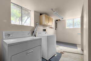 Laundry room with washing machine and dryer and cabinet space