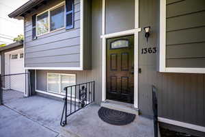 View of exterior entry featuring covered porch